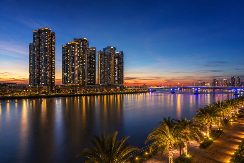 High rise apartment towers on the Han River in Da Nang lit up at dusk